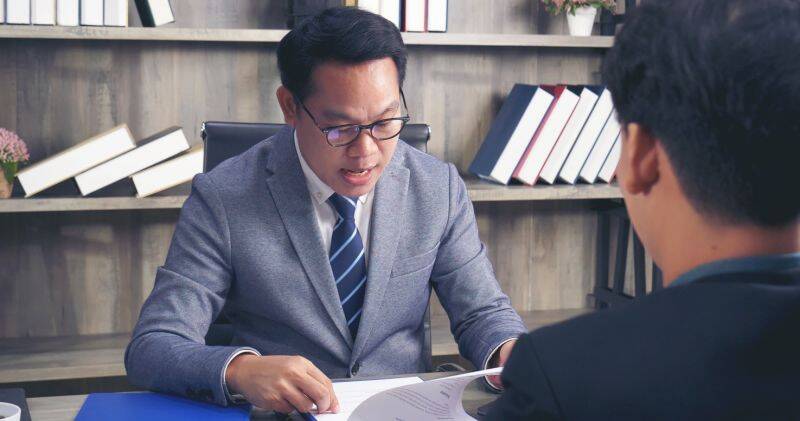 Illustration of a professional interview with a candidate asking questions about wealth management, including compensation and firm goals.