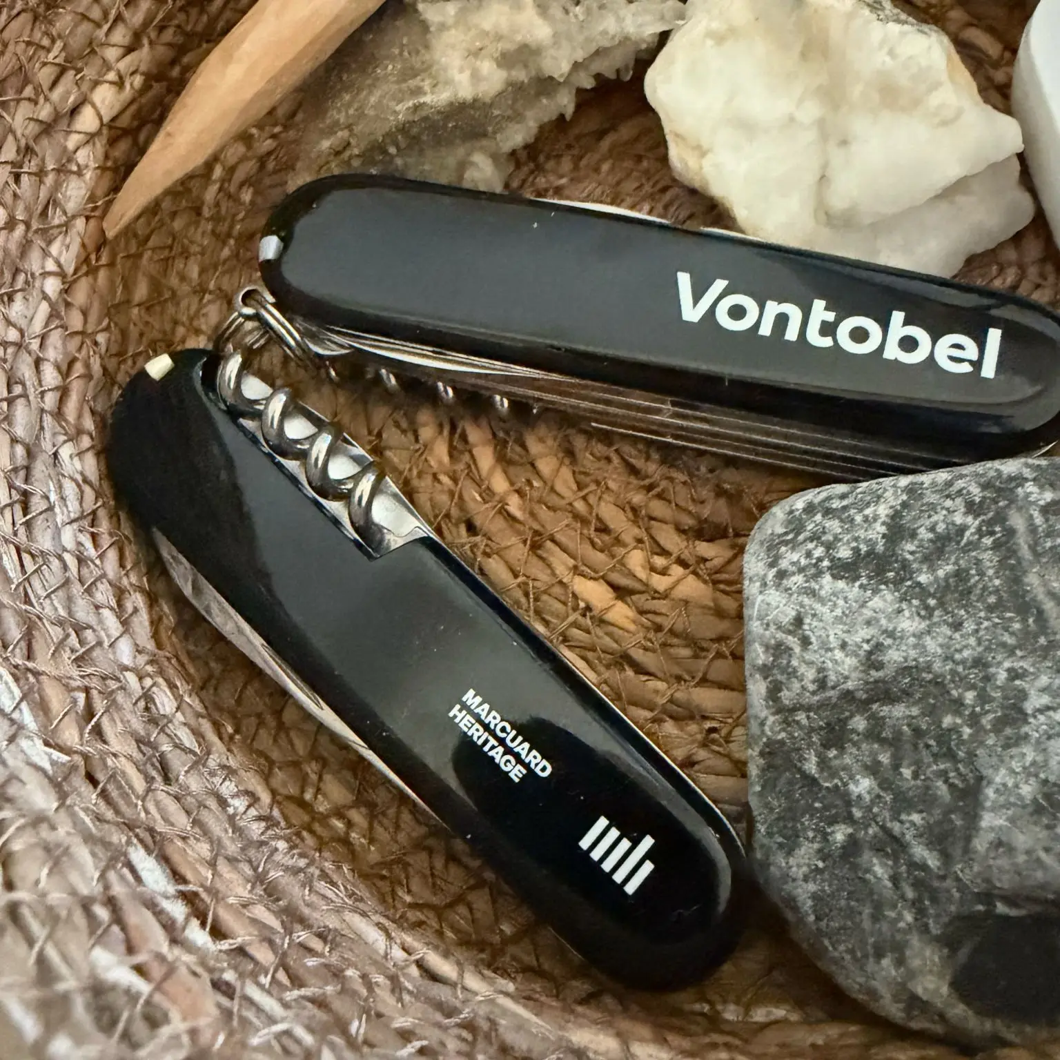 Bank or independent wealth manager: two Swiss Army knives with different logos in a basket