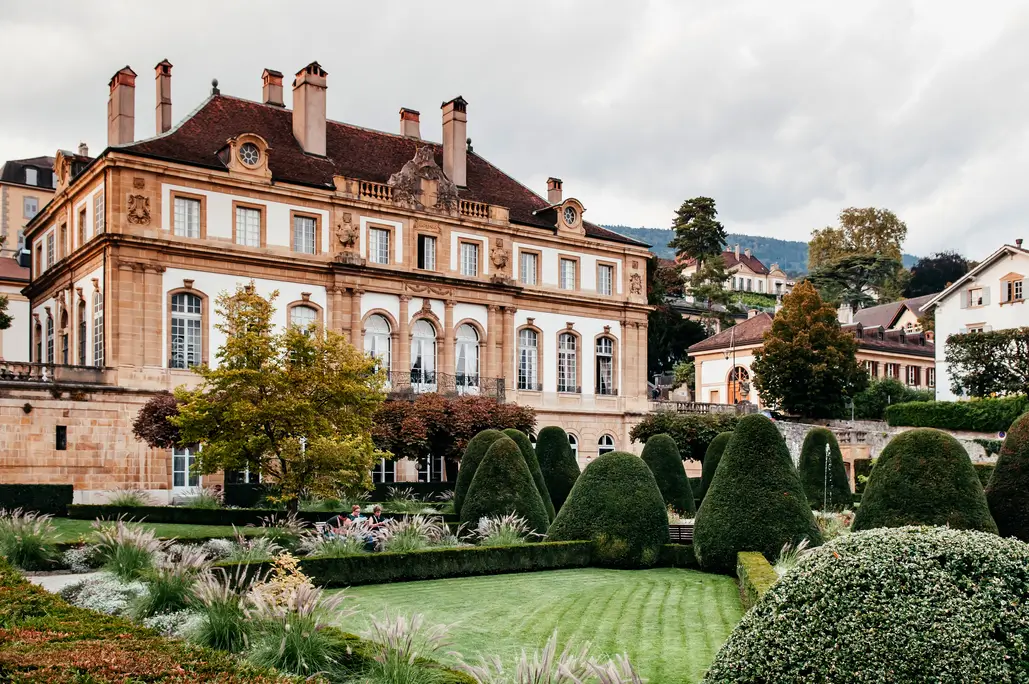 Historic Swiss manor house and private estate garden representing the discreet world of single family offices in Switzerland