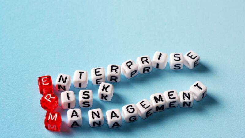 Cubes spelling out "Enterprise Risk Management" (ERM), symbolising strategic risk control to protect your job.